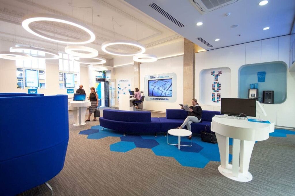 KBC Bank with bright lights and blue furniture by Douglas Wallace Architects
